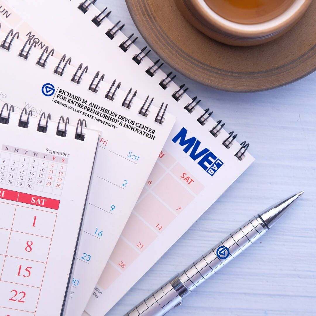 Calendars, cup of coffee, with a pen.